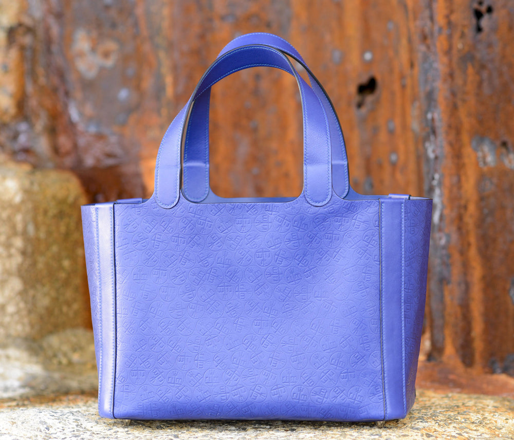 "Rachael" tote in electric blue. Leather from the Hermes tannery. With all-over embossed monogram of the clients initials. Entirely hand sewn in Malibu, CA by Ben Hogestyn