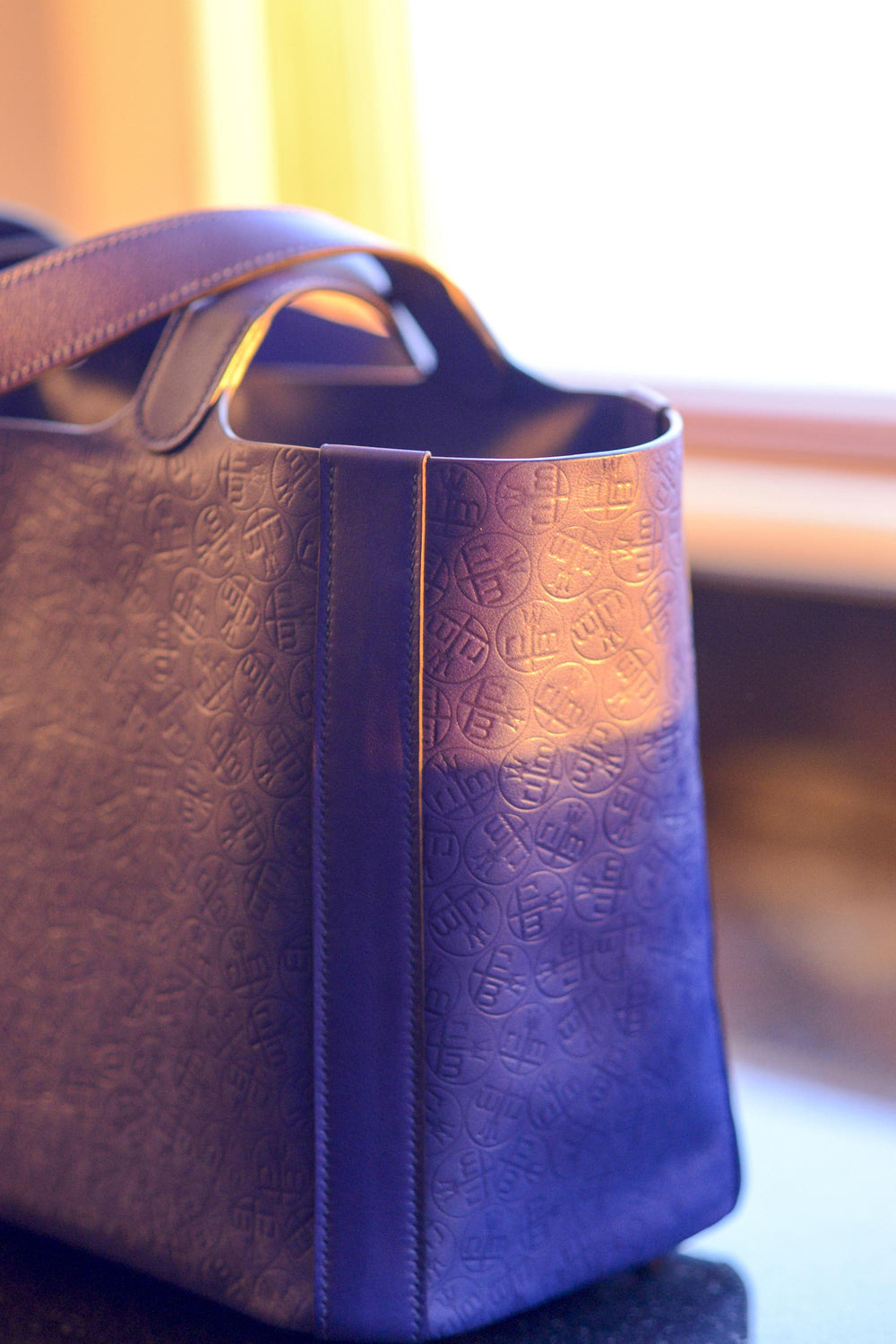 "Rachael" tote in electric blue. Leather from the Hermes tannery. With all-over embossed monogram of the clients initials. Entirely hand sewn in Malibu, CA by Ben Hogestyn